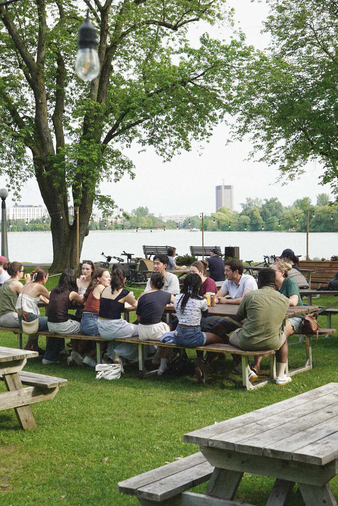 A crowd gathered at picnic tables by the water at Bar Lakeside, Dow’s Lake